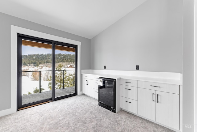 224 Meadow Lake Ct, Mccall, ID 83638 - indoor dry bar featuring beverage cooler, lofted ceiling, light carpet, and plenty of natural light