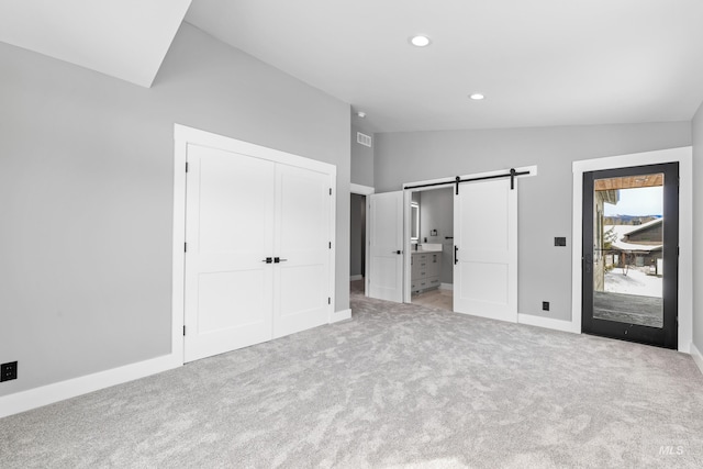 224 Meadow Lake Ct, Mccall, ID 83638 - unfurnished bedroom featuring vaulted ceiling, a barn door, carpet, recessed lighting, and baseboards