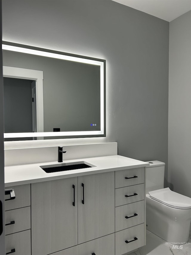 bathroom featuring vanity and toilet