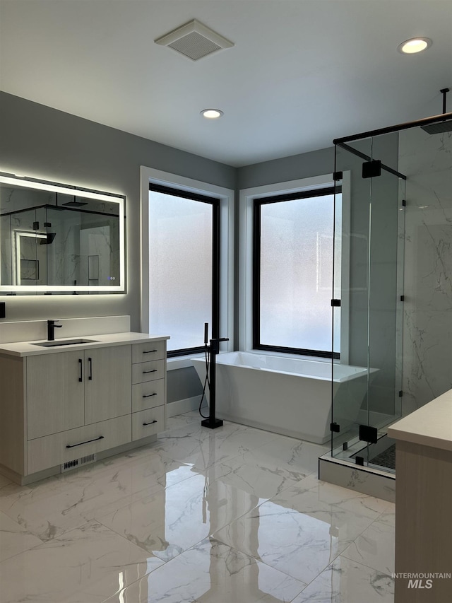 full bath with vanity, a marble finish shower, recessed lighting, visible vents, and a soaking tub