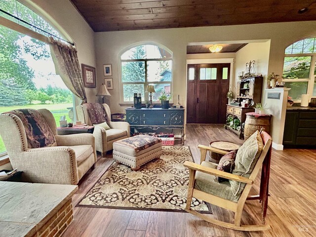 living room featuring light wood-type flooring and wooden ceiling