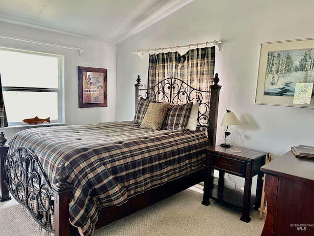 bedroom featuring carpet floors and vaulted ceiling