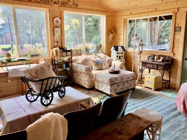 living room with wood walls and lofted ceiling