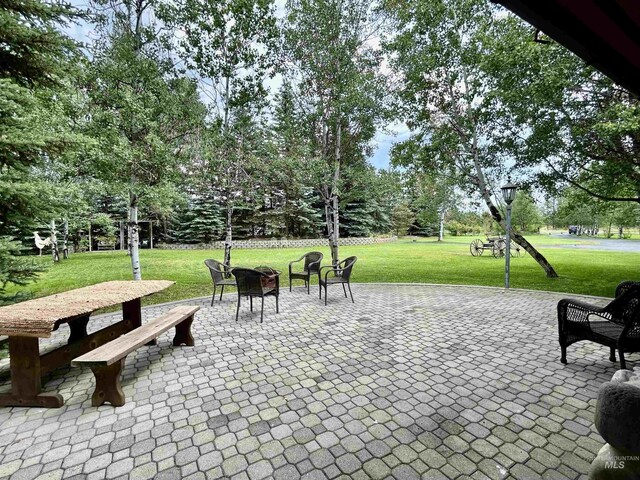 view of community featuring a patio and a lawn