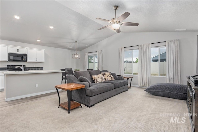 5144 W W Grand Rapids Dr, Meridian, ID 83646 - living area with lofted ceiling, a ceiling fan, and recessed lighting