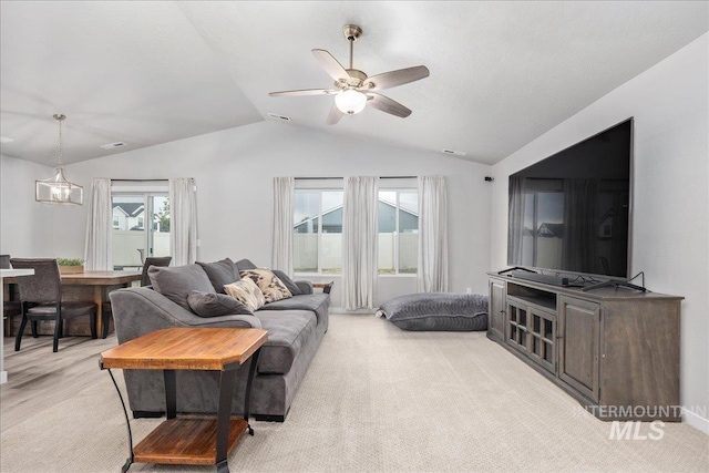 5144 W W Grand Rapids Dr, Meridian, ID 83646 - living room featuring vaulted ceiling, light carpet, and a ceiling fan