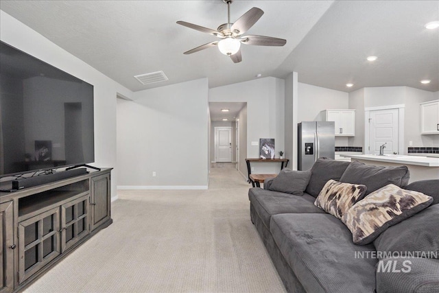 5144 W W Grand Rapids Dr, Meridian, ID 83646 - living room featuring light carpet, lofted ceiling, ceiling fan, baseboards, and recessed lighting
