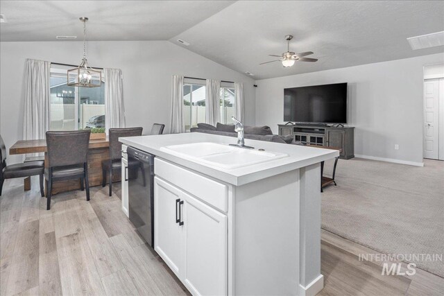 5144 W W Grand Rapids Dr, Meridian, ID 83646 - kitchen featuring a sink, black dishwasher, vaulted ceiling, light countertops, and decorative light fixtures