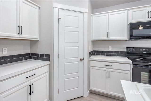 5144 W W Grand Rapids Dr, Meridian, ID 83646 - kitchen featuring black appliances, white cabinetry, light wood-style floors, and light countertops