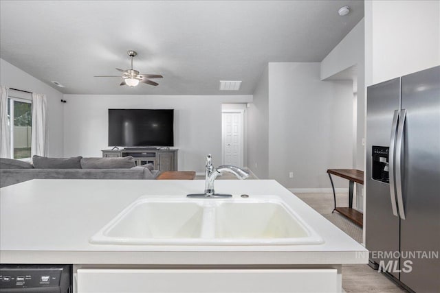 5144 W W Grand Rapids Dr, Meridian, ID 83646 - kitchen with stainless steel refrigerator with ice dispenser, a sink, ceiling fan, light countertops, and dishwashing machine