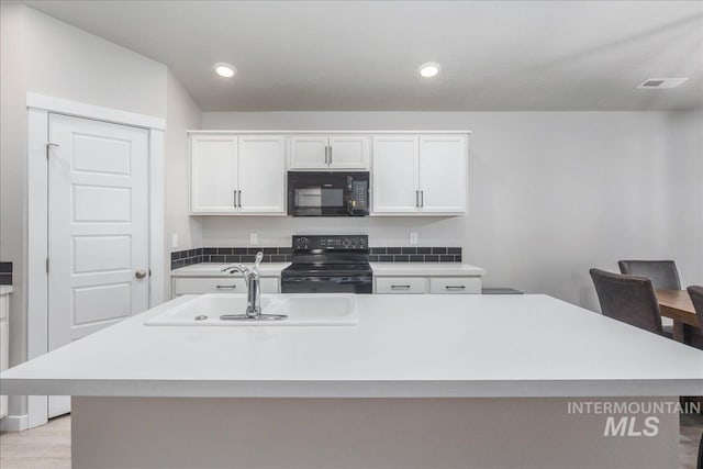 5144 W W Grand Rapids Dr, Meridian, ID 83646 - kitchen with black appliances, a sink, light countertops, and recessed lighting