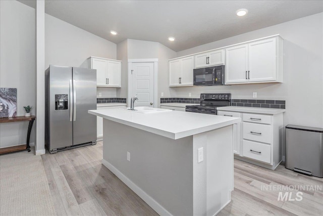 5144 W W Grand Rapids Dr, Meridian, ID 83646 - kitchen featuring stainless steel fridge with ice dispenser, electric range oven, black microwave, a sink, and white cabinets