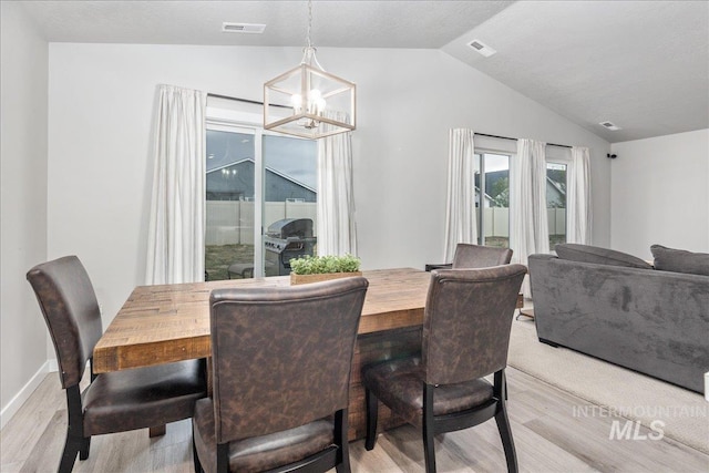 5144 W W Grand Rapids Dr, Meridian, ID 83646 - dining space with light wood-style flooring, a chandelier, and lofted ceiling