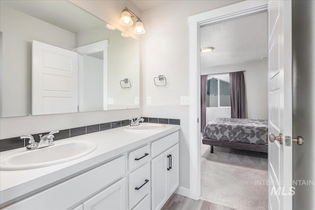 5144 W W Grand Rapids Dr, Meridian, ID 83646 - ensuite bathroom with double vanity and wood finished floors