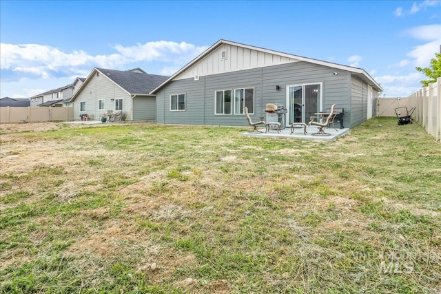 5144 W W Grand Rapids Dr, Meridian, ID 83646 - rear view of property with a patio area and board and batten siding