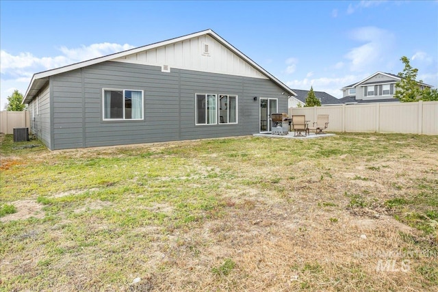 5144 W W Grand Rapids Dr, Meridian, ID 83646 - rear view of property with board and batten siding, a patio, and cooling unit