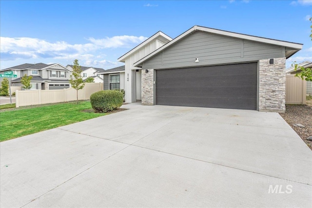 5144 W W Grand Rapids Dr, Meridian, ID 83646 - single story home with stone siding, a garage, concrete driveway, and a residential view
