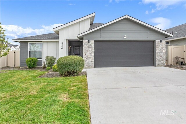 5144 W W Grand Rapids Dr, Meridian, ID 83646 - single story home with board and batten siding, a garage, driveway, stone siding, and a shingled roof