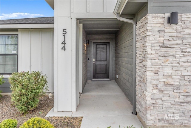 5144 W W Grand Rapids Dr, Meridian, ID 83646 - view of exterior entry with board and batten siding and a shingled roof