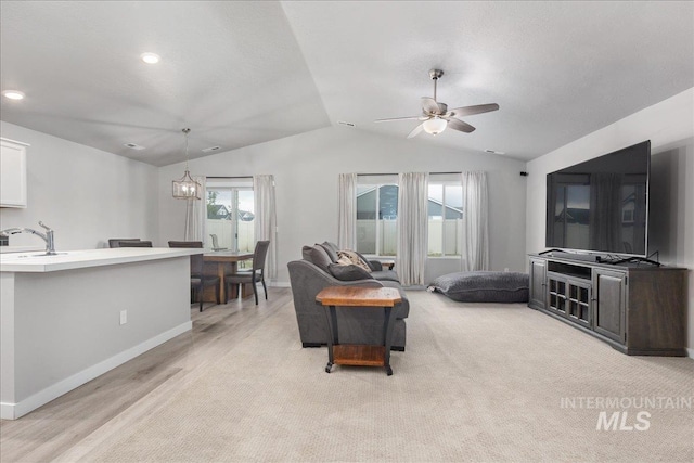 5144 W W Grand Rapids Dr, Meridian, ID 83646 - living room with lofted ceiling, ceiling fan, light wood-type flooring, baseboards, and recessed lighting