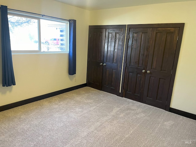 unfurnished bedroom with light carpet