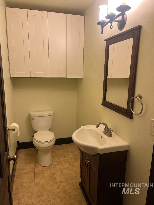 bathroom featuring tile patterned floors, vanity, and toilet