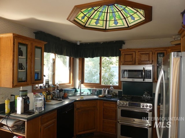 2597 Price Valley Rd, New Meadows, ID 83654 - kitchen featuring stainless steel appliances, a sink, brown cabinets, glass insert cabinets, and dark countertops