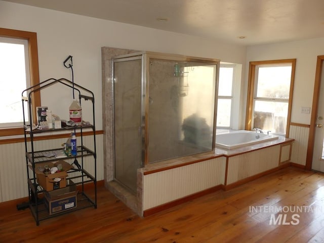 2597 Price Valley Rd, New Meadows, ID 83654 - full bathroom featuring hardwood / wood-style floors, a stall shower, a bath, and baseboards