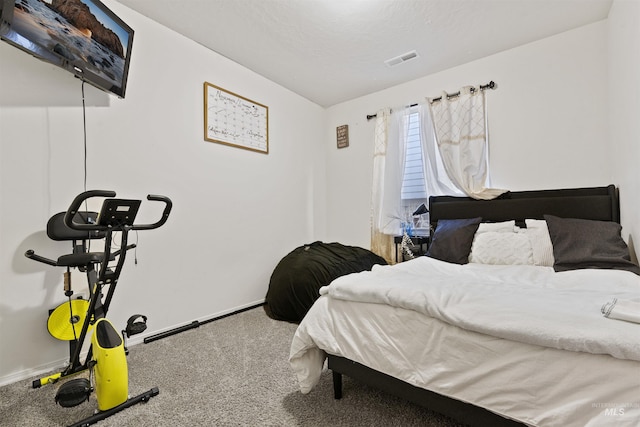 bedroom with carpet and a textured ceiling