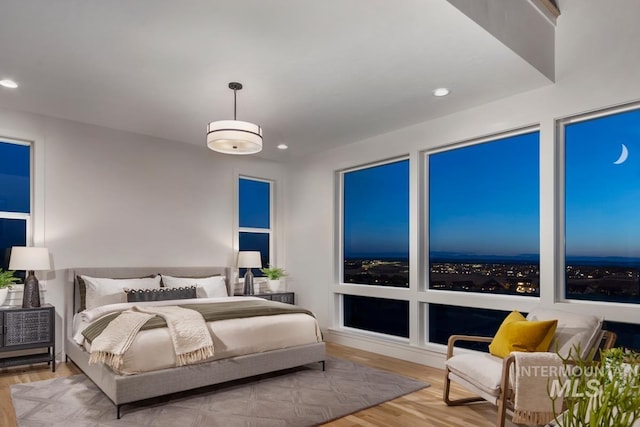 bedroom with recessed lighting and wood finished floors