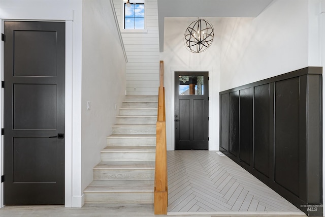 stairway with a chandelier