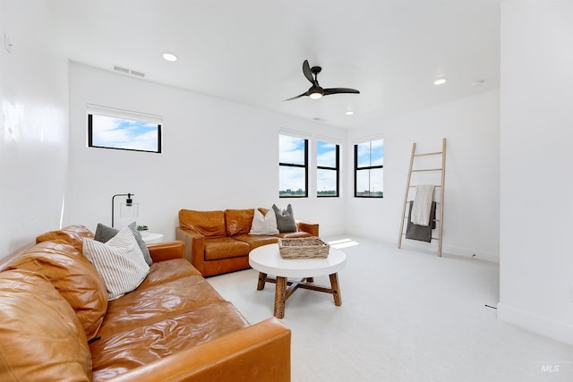living room with ceiling fan, recessed lighting, light colored carpet, and baseboards