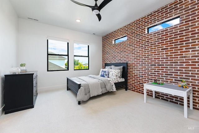 bedroom with carpet floors, brick wall, a ceiling fan, baseboards, and an accent wall