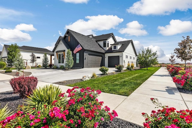 view of side of property featuring board and batten siding, driveway, a lawn, and an attached garage