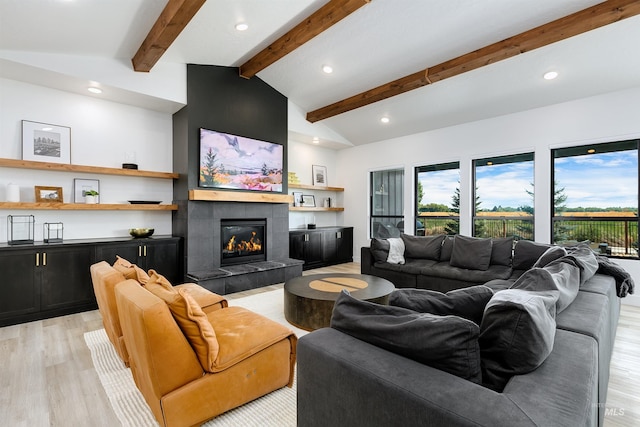 living area with light wood-type flooring, plenty of natural light, recessed lighting, and a tiled fireplace