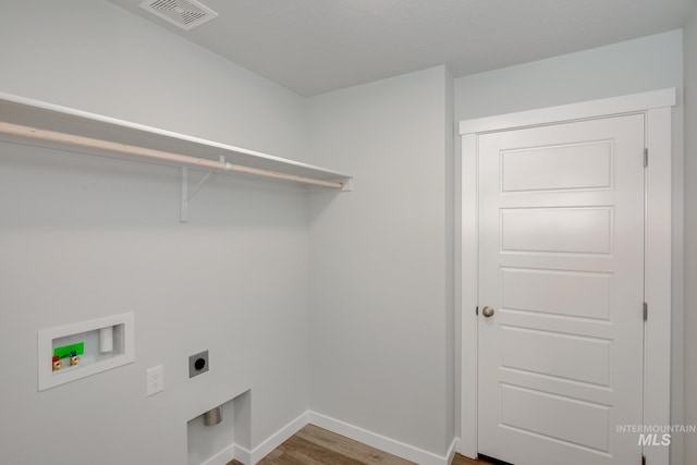 laundry room with electric dryer hookup, visible vents, baseboards, hookup for a washing machine, and laundry area