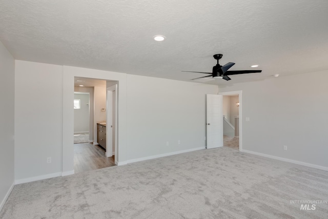 unfurnished bedroom with baseboards, carpet floors, recessed lighting, a textured ceiling, and connected bathroom