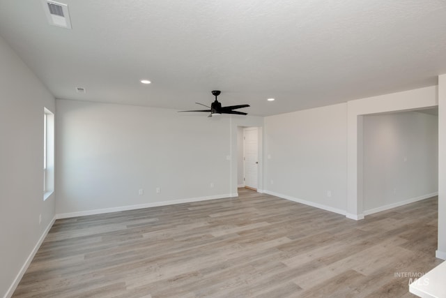 unfurnished room with baseboards, visible vents, recessed lighting, ceiling fan, and light wood-type flooring