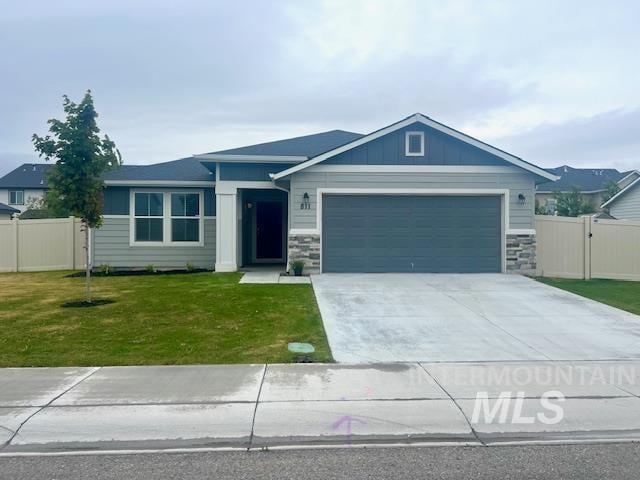 811 Pronghorn Dr, Twin Falls, ID 83301 - single story home with an attached garage, concrete driveway, stone siding, board and batten siding, and a gate