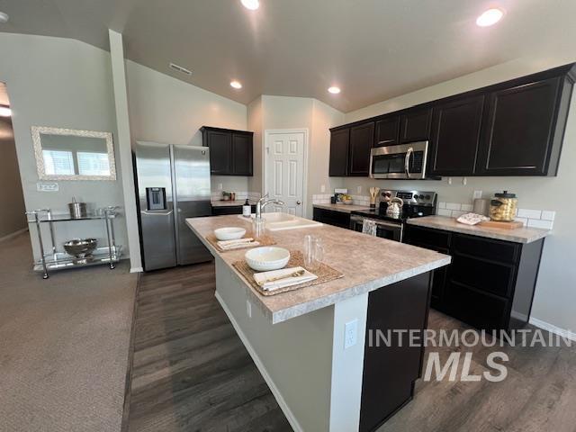 811 Pronghorn Dr, Twin Falls, ID 83301 - kitchen with stainless steel appliances, a sink, light countertops, lofted ceiling, and a center island with sink