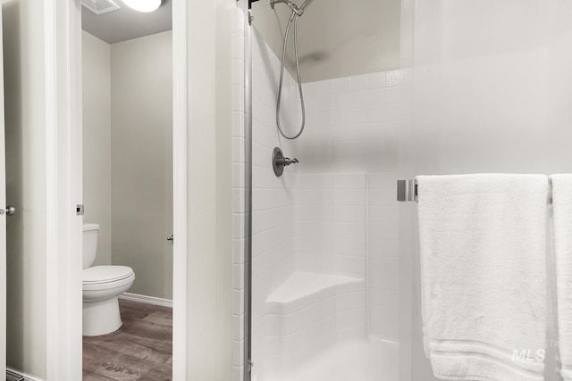 811 Pronghorn Dr, Twin Falls, ID 83301 - full bathroom with a stall shower, wood finished floors, toilet, and baseboards