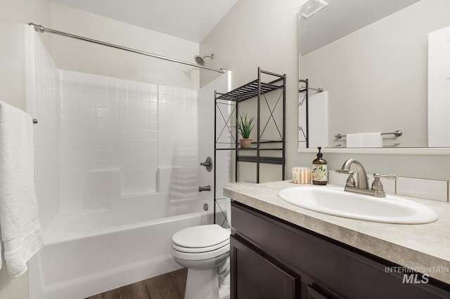 811 Pronghorn Dr, Twin Falls, ID 83301 - bathroom featuring vanity, washtub / shower combination, wood finished floors, and toilet