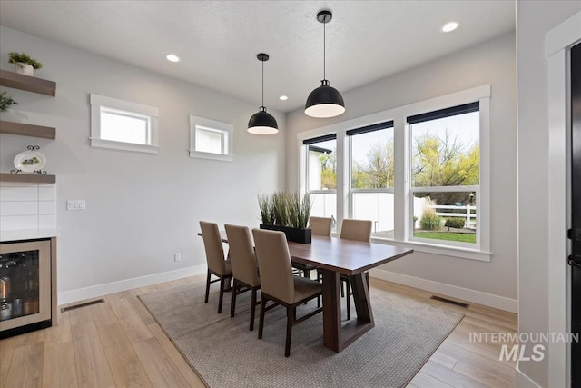 8749 W Suttle Lake Dr, Boise, ID 83714 - dining area with recessed lighting, beverage cooler, visible vents, light wood-type flooring, and baseboards