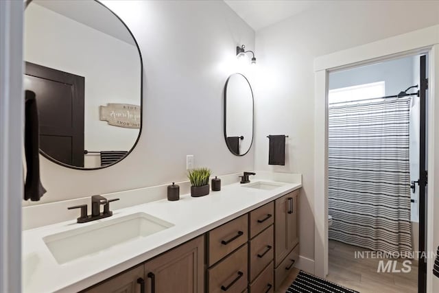 8749 W Suttle Lake Dr, Boise, ID 83714 - bathroom featuring wood finished floors, a sink, double vanity, and curtained shower