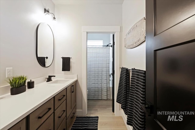 8749 W Suttle Lake Dr, Boise, ID 83714 - full bath with baseboards, wood finished floors, and vanity