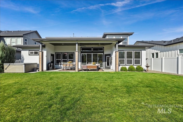 8749 W Suttle Lake Dr, Boise, ID 83714 - back of house featuring fence, stucco siding, a patio area, a lawn, and a hot tub