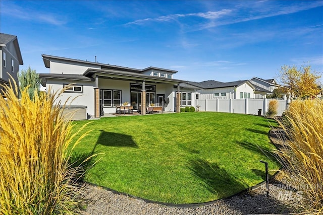 8749 W Suttle Lake Dr, Boise, ID 83714 - rear view of house with a ceiling fan, fence, stucco siding, a patio, and a lawn