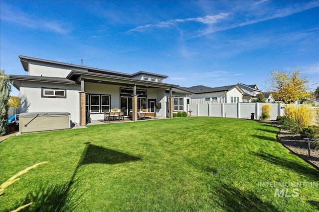 8749 W Suttle Lake Dr, Boise, ID 83714 - rear view of property with fence, a ceiling fan, a yard, a patio, and stucco siding
