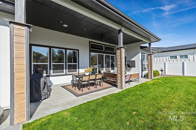 8749 W Suttle Lake Dr, Boise, ID 83714 - back of house with a ceiling fan, fence, a yard, stucco siding, and a patio