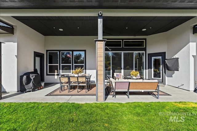 8749 W Suttle Lake Dr, Boise, ID 83714 - back of property featuring a patio area, a lawn, and stucco siding